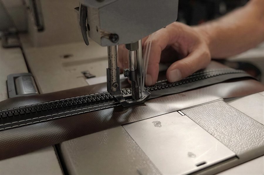 Industrial stitching process on heavy-duty material at Alarvell